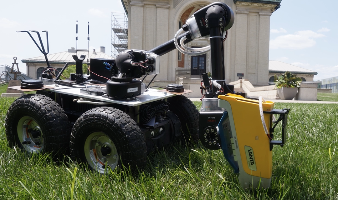 Wheeled robot on the lawn in front of Hamerschlag Hall