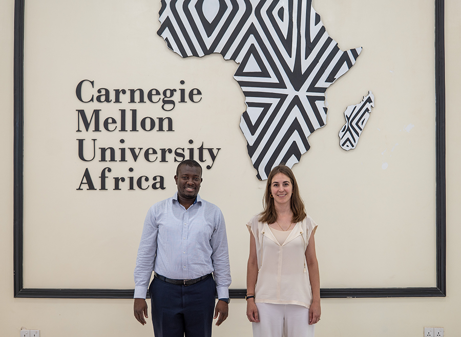 A man and a woman in front of the CMU-Africa logo