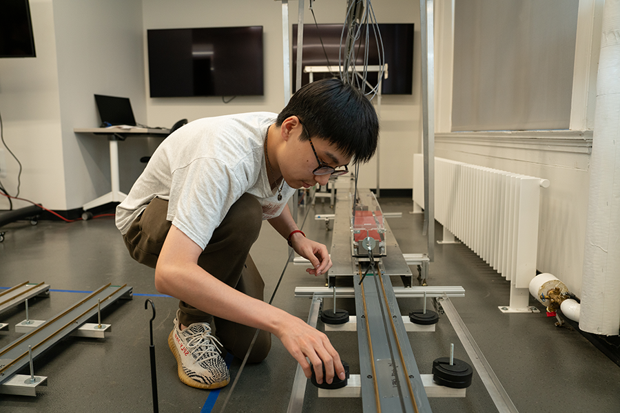 Student placing sensors on the testbed track