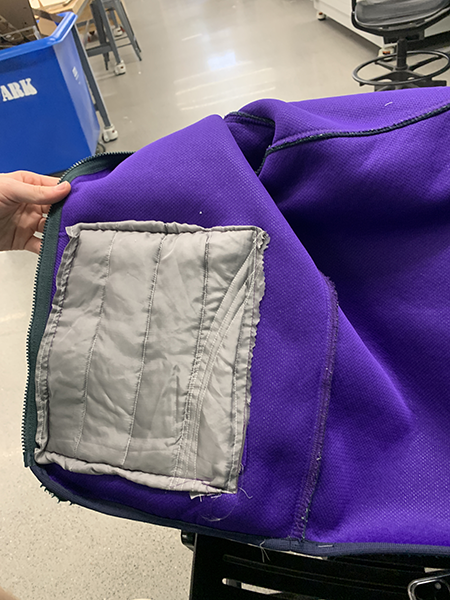 The inside of a hoodie is shown to demonstrate the pocket was repaired.