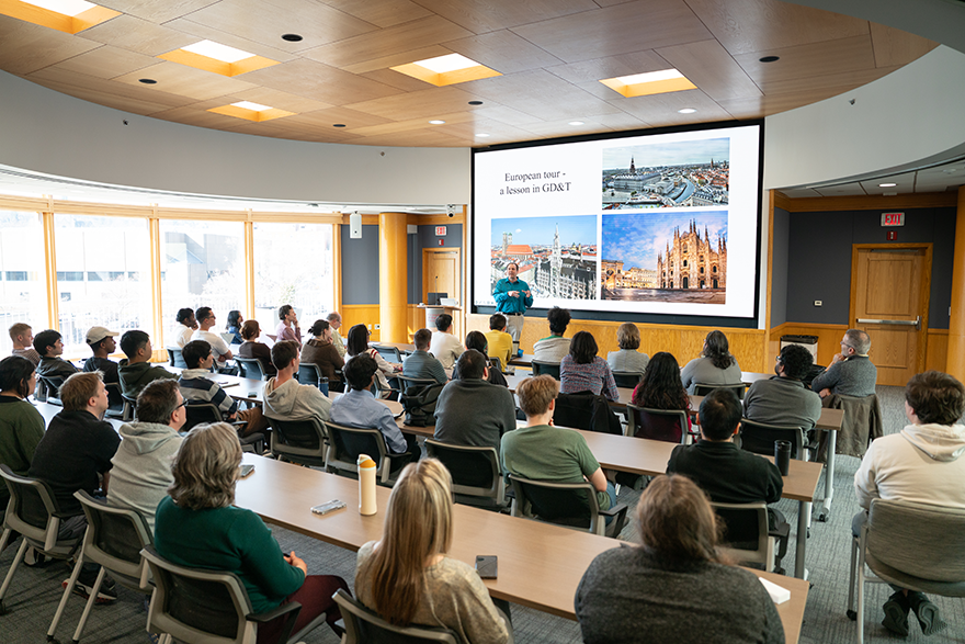 Room of people listening to a presentation