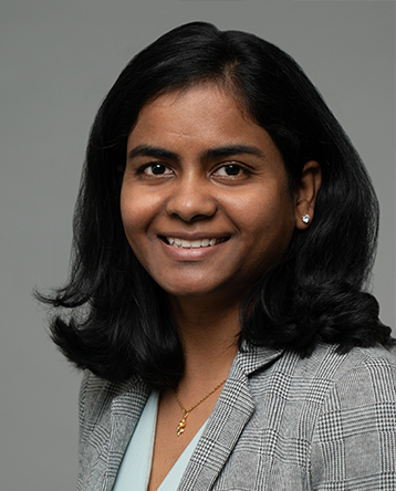 A woman with dark hair wearing a suit