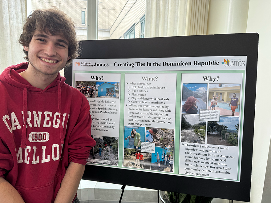 Student with Juntos project poster