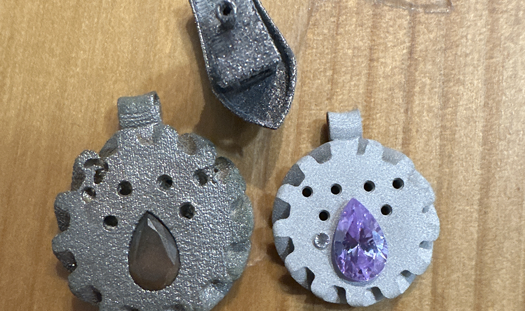 3d printed jewelry, including two pendants and a purple stone