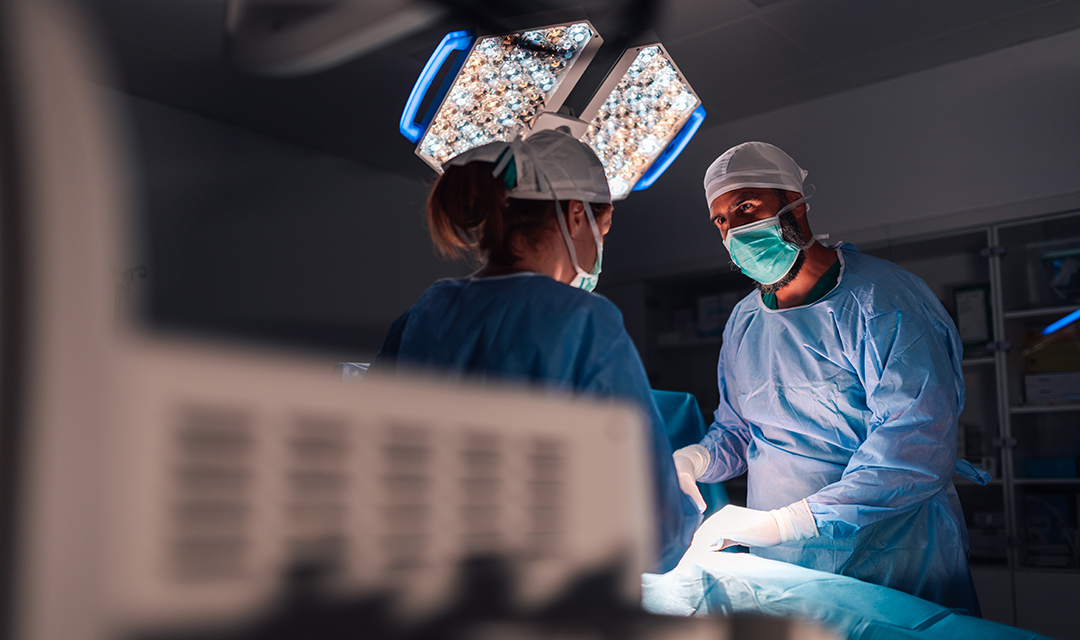 A male and female doctor performing surgery