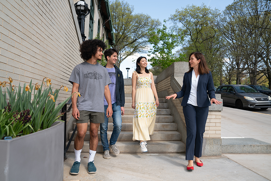 Four people walking down outdoor stairs