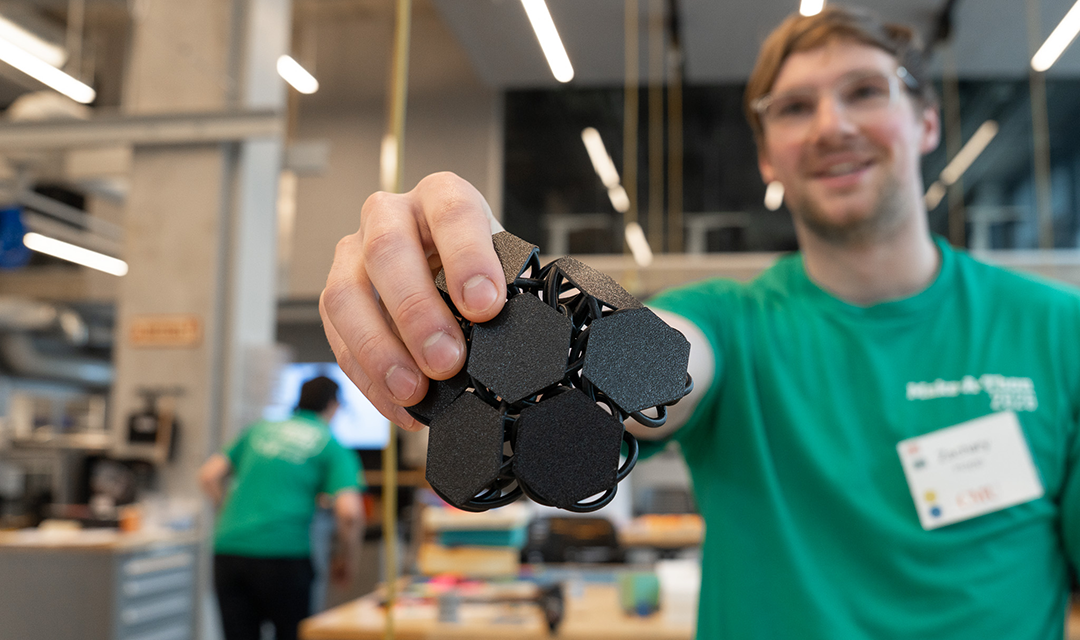A student holding a prototype