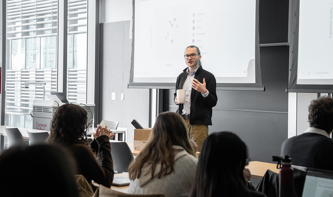 Chris McComb teaching in front of a classroom