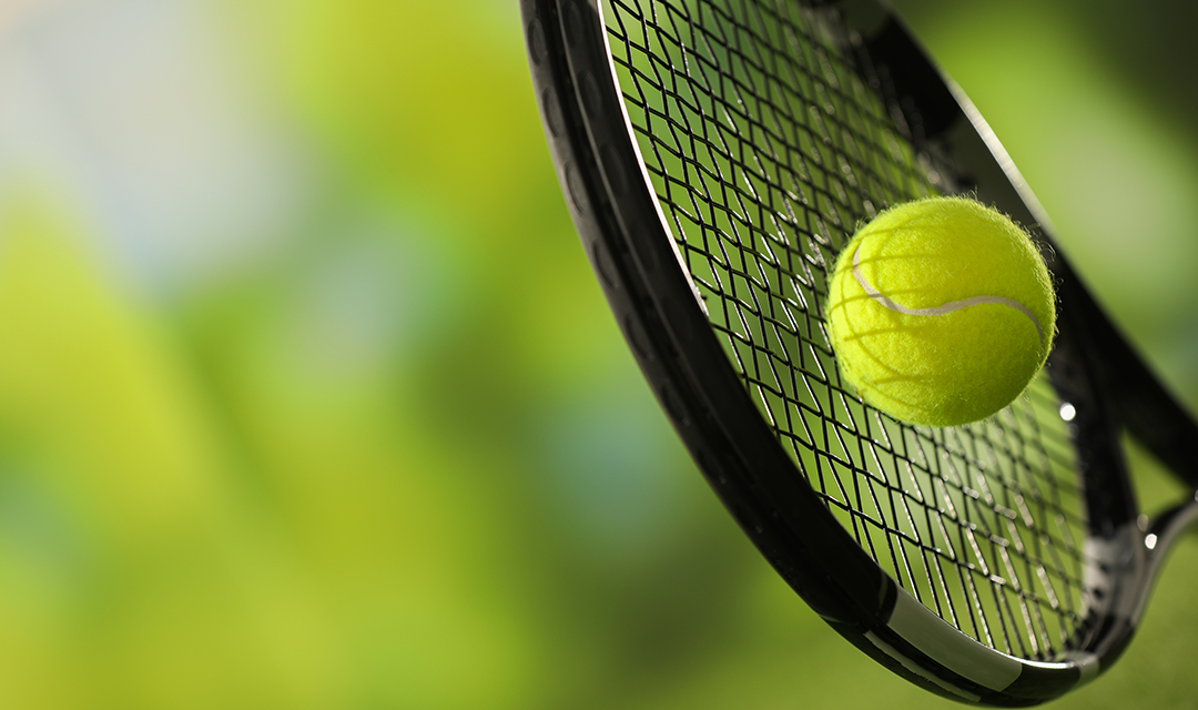 A tennis racket hitting a tennis ball