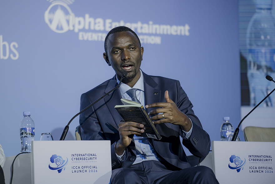 A man talking while holding a book