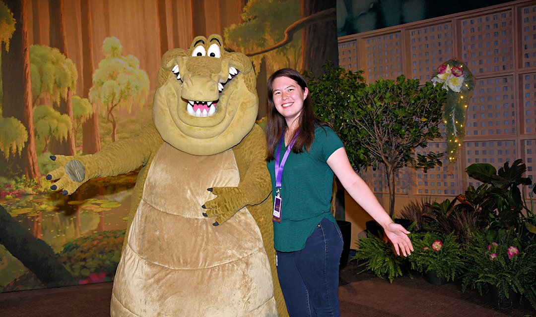 Lori Kipp with an actor dressed as one of the alligators from The Princess and the Frog