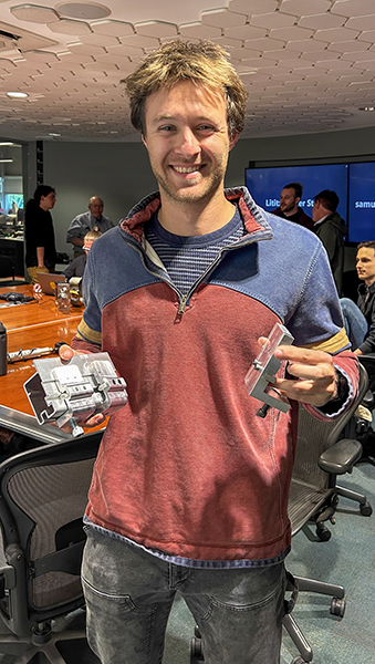 A student holding two different metal parts