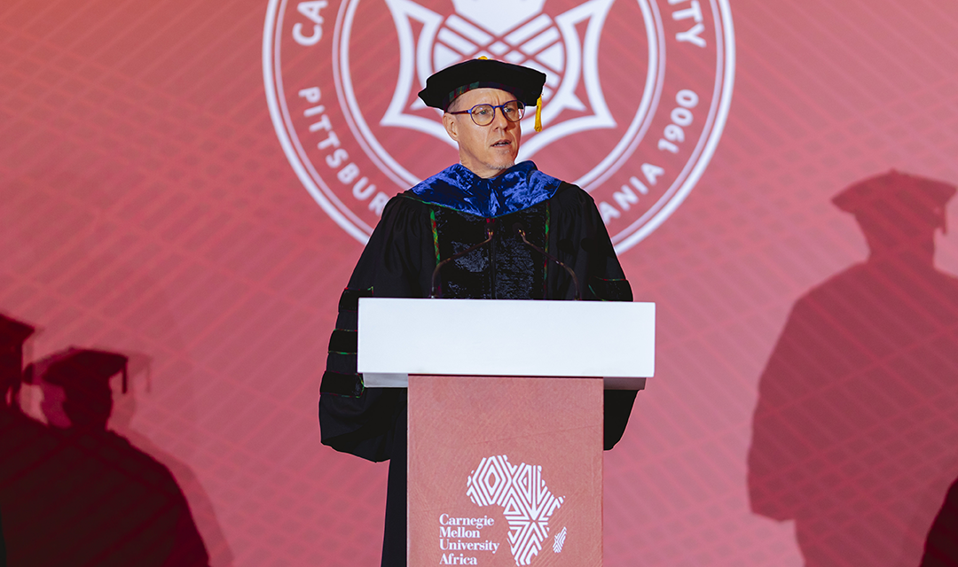 Tim Brown at a podium at graduation