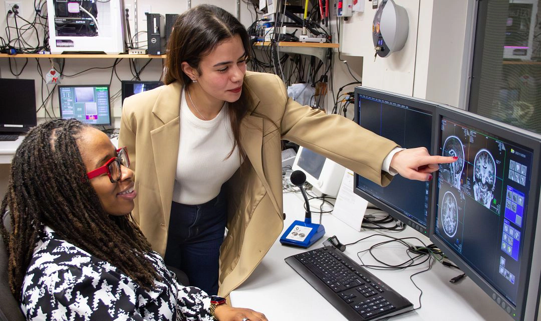 Lara Abdelmohsen and Sossena Wood look at imaging on a computer screen