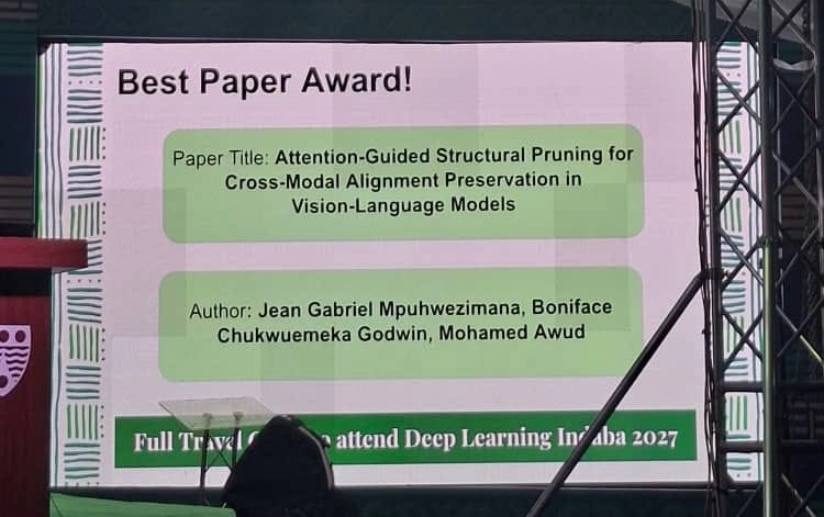 Conference slide announcing a Best Paper Award, showing the paper title and authors’ names on a large screen.