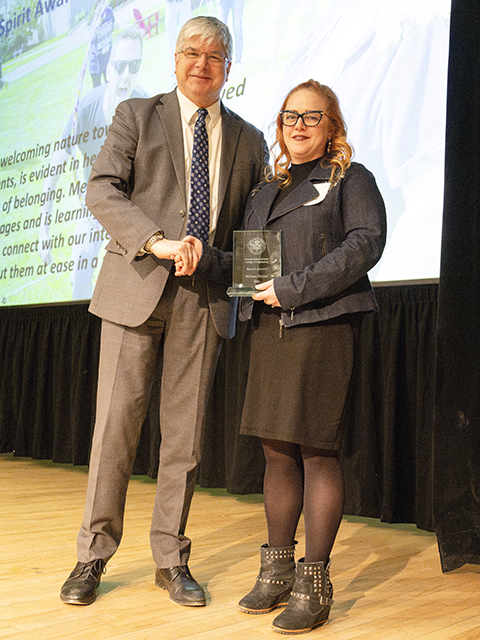 Melissa Ritchie standing with Dean Sanders holding her award