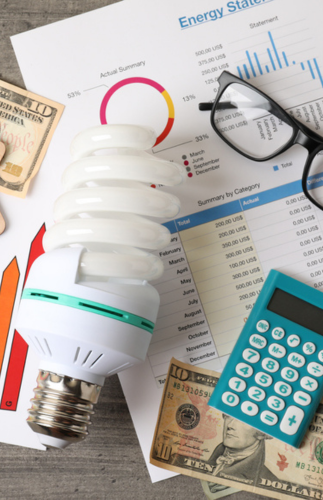 Flat lay with glasses, an energy bill, and money on the table