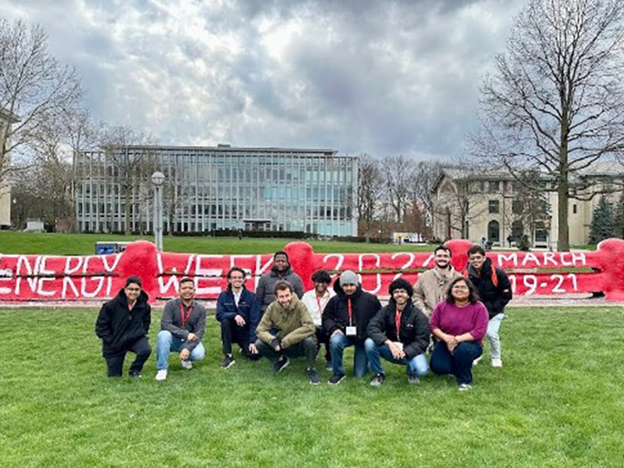 students pose for photo outside of CMU's Fence