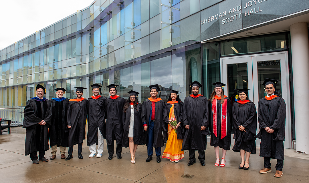 ESTP graduates pose for photo in cap and gown
