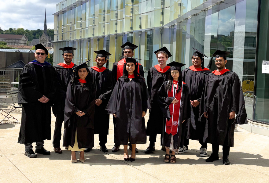 ESTP graduates pose for photo in caps and gowns