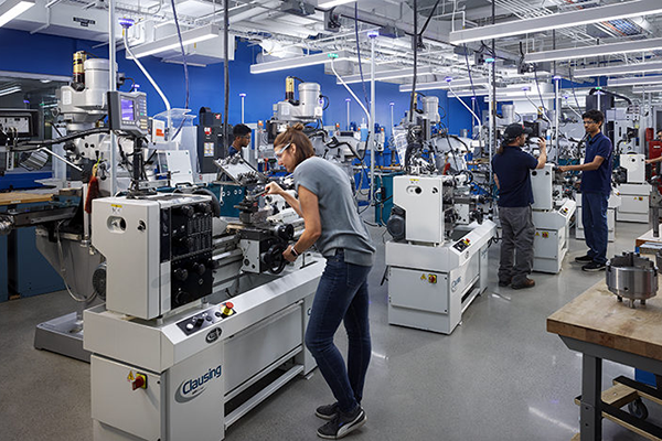 A student in tech spark working on a machine